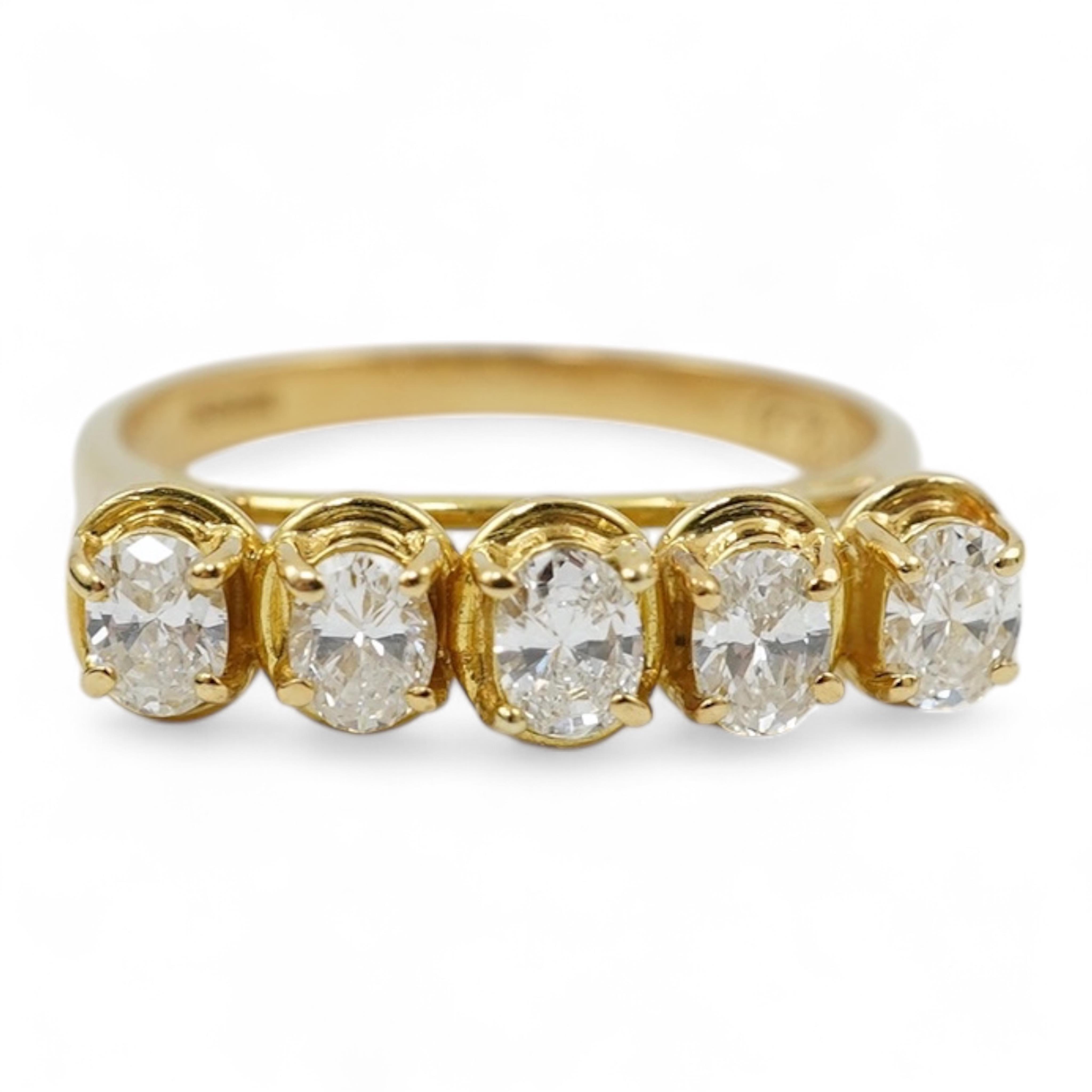 A modern 18ct gold and five stone oval cut diamond set half hoop ring, size N, gross weight 3.8 grams.